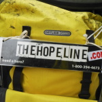 TheHopeLine sign on Tim's pannier